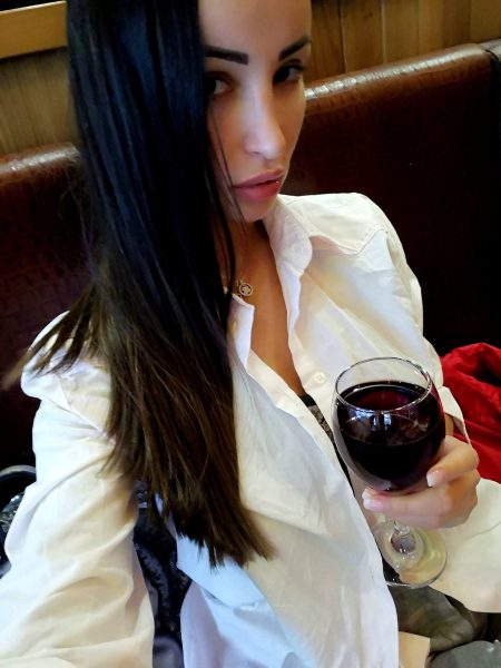 adult model Alyssia Kent drinking some red wine