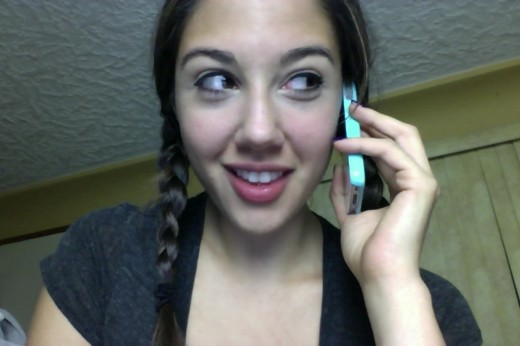 Ceara Lynch with braided pigtails on the phone